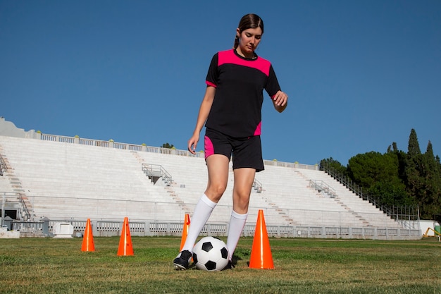 Full shot woman football player on field