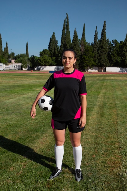 Free photo full shot woman football player on field