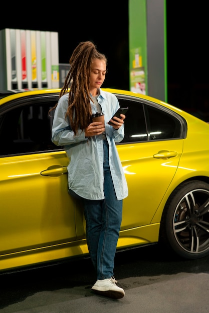 Free photo full shot woman at gas station