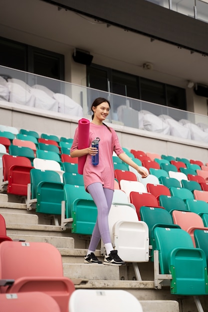 Free photo full shot woman going down stairs