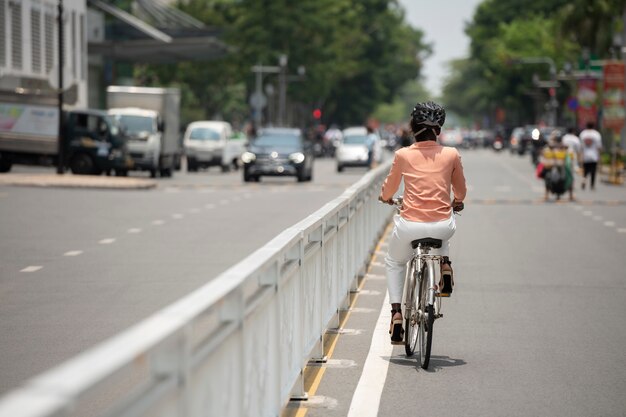 Full shot woman going to work on bicycle