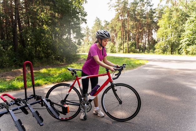 Full shot woman holding bicycle