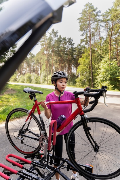 Full shot woman holding bicycle