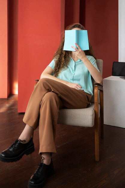 Full shot woman holding book