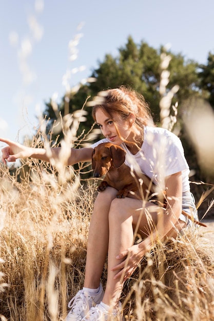 Full shot woman holding cute dog