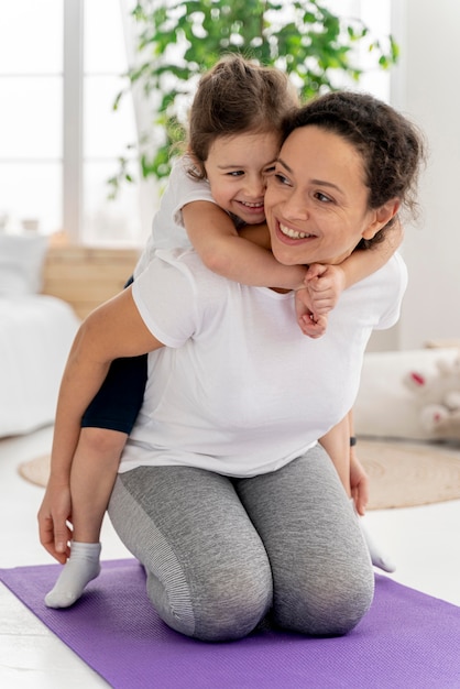 Full shot woman holding girl on back