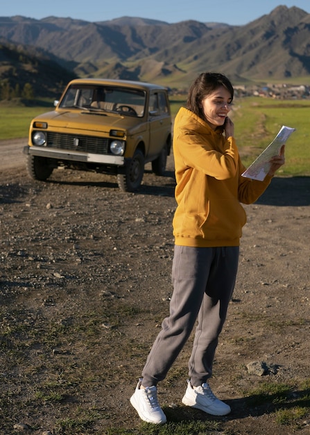 Free photo full shot woman holding map