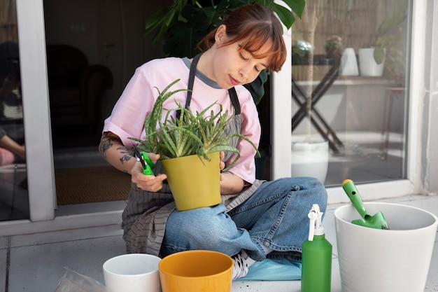 Full shot woman holding pot