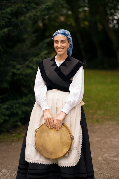 Free Photo full shot woman holding tambourine