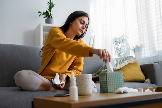 Full shot woman holding tissue