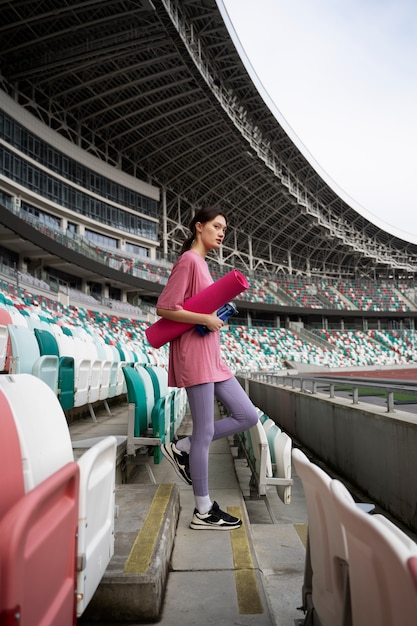 Free Photo full shot woman holding yoga mat