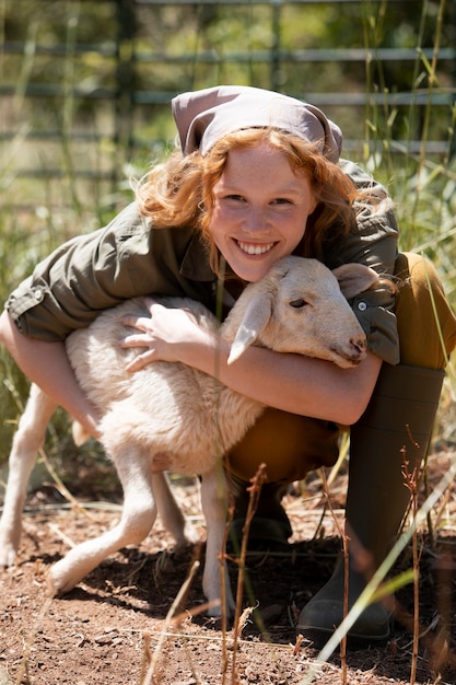 Free Photo full shot woman hugging lamb