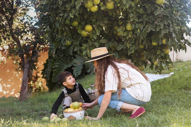 Free photo full shot woman and kid on grass