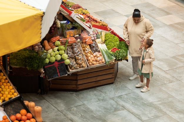 Free Photo full shot woman and kid at market