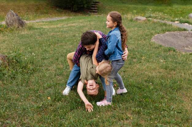 Full shot woman and kids playing