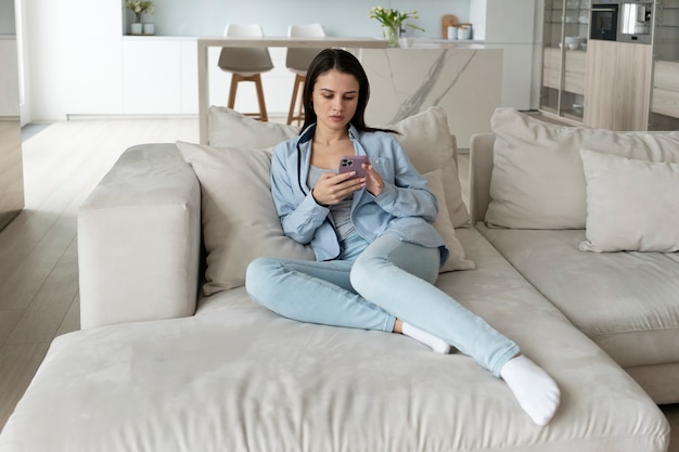 Full shot woman laying on couch