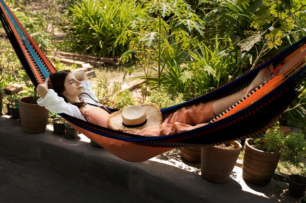 Full shot woman laying in hammock