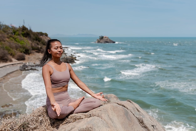 Free Photo full shot woman meditating outdoors