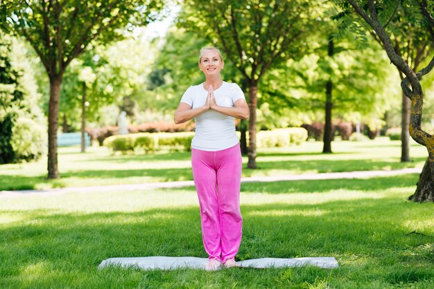 Full shot woman meditating position outdoors