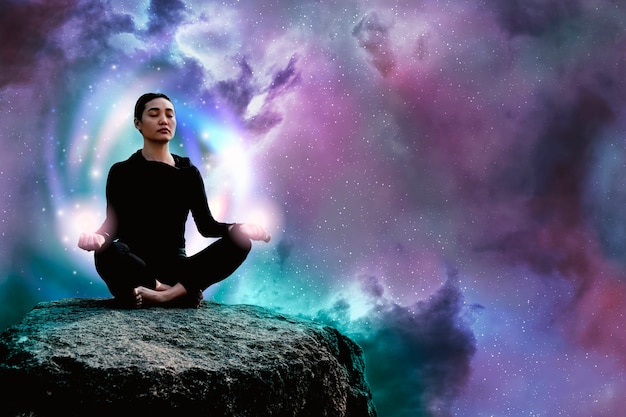 Full shot woman meditating on rock