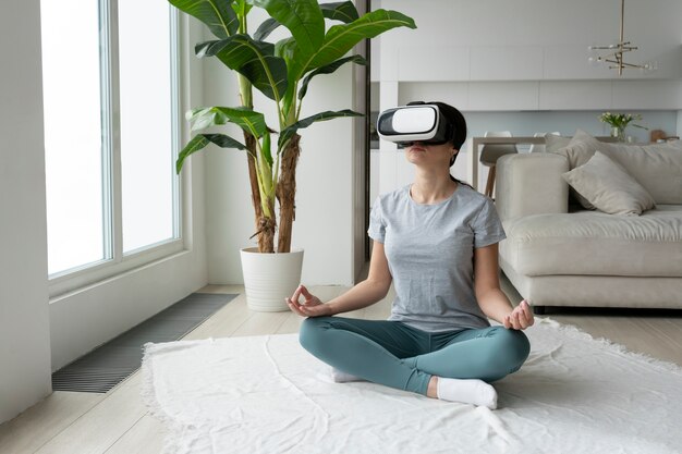 Full shot woman meditating with vr glasses