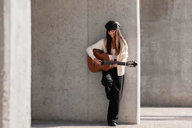 Free Photo full shot woman playing the guitar