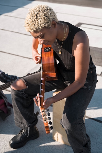 Free Photo full shot woman playing the guitar