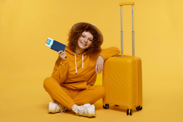 Full shot woman posing with baggage