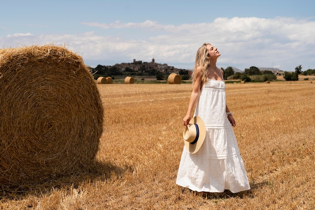 Free Photo full shot woman posing with hat