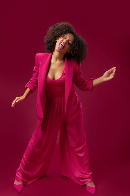 Full shot woman posing with pink outfit