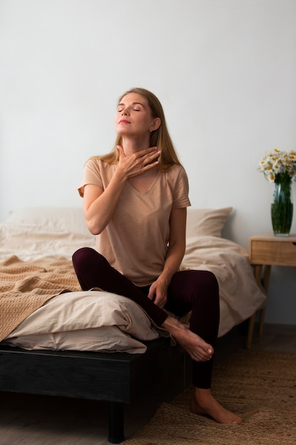 Free photo full shot woman practicing facial yoga