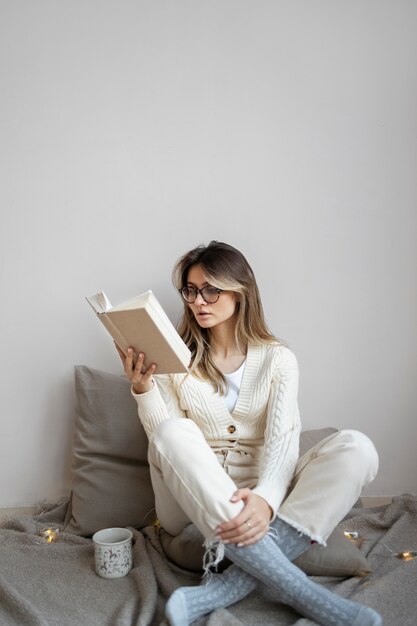 Full shot woman reading at home