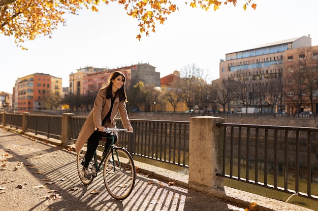 Full shot woman riding bicycle