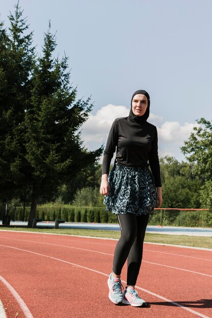 Full shot of woman at running track