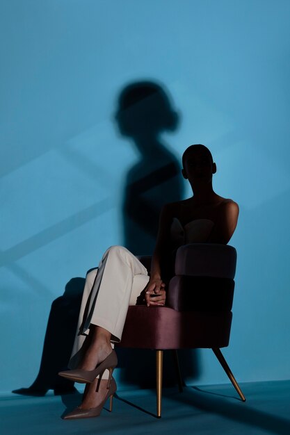 Full shot woman sitting on chair