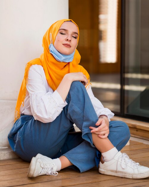 Full shot woman sitting on floor