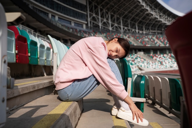 Full shot woman sitting on grandstands