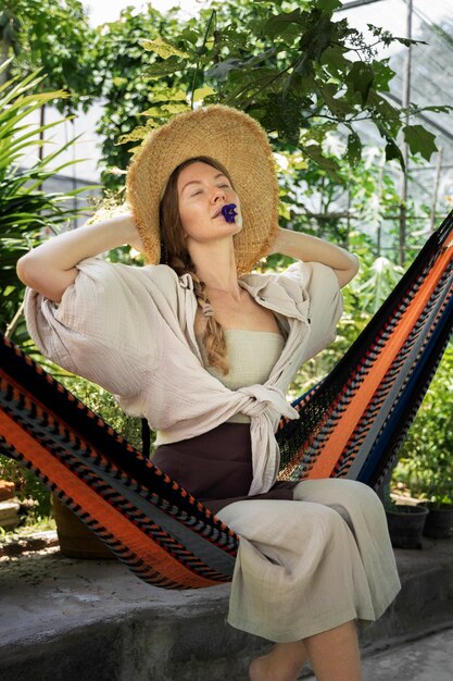 Full shot woman sitting in hammock