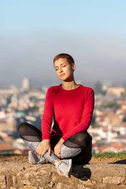 Full shot of woman sitting outdoors