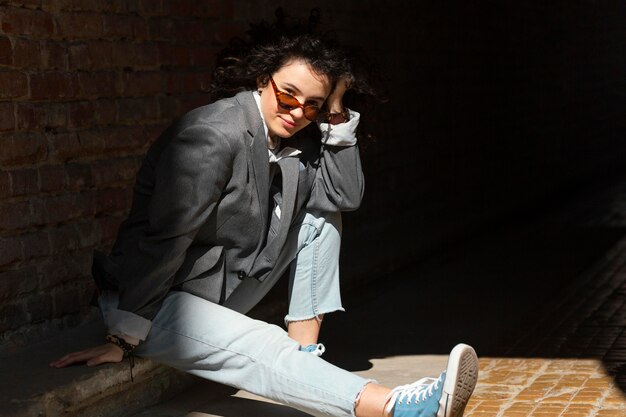 Full shot woman sitting outdoors