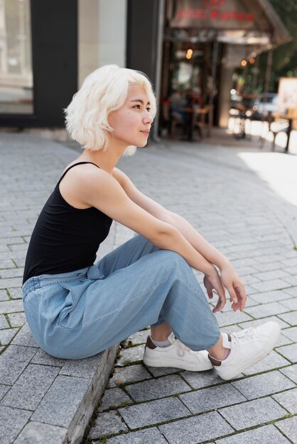 Full shot woman sitting outdoors