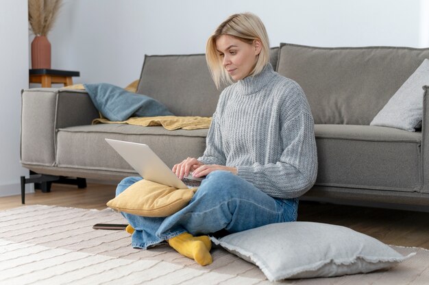 Full shot woman sitting on pillow