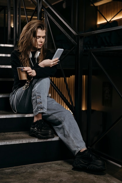 Free photo full shot woman sitting on stairs