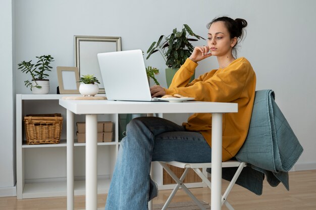 Full shot woman sitting at table