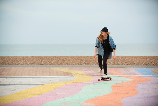 Full shot woman on skateboard