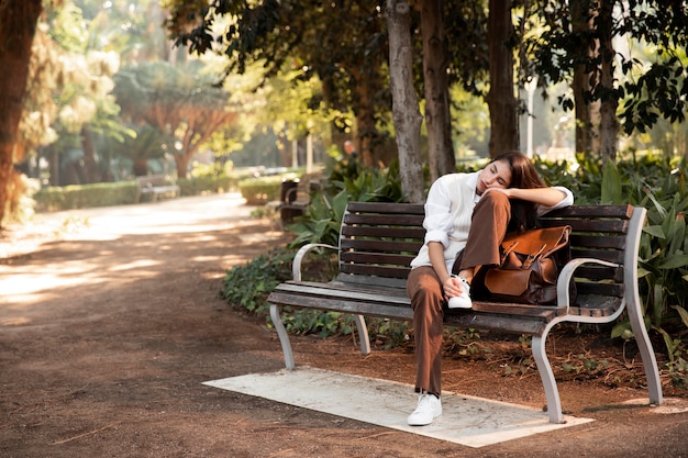 Free photo full shot woman sleeping in nature