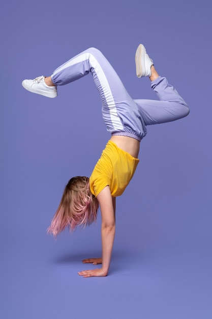 Full shot woman standing on hands