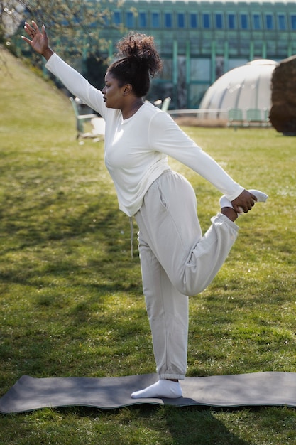 Full shot woman stretching leg