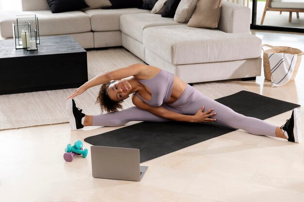 Full shot woman stretching on mat