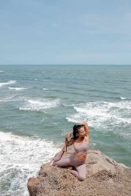 Free photo full shot woman stretching in nature